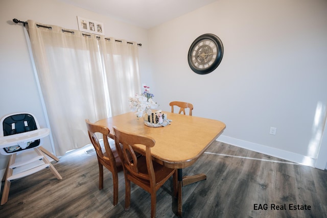 dining area featuring wood finished floors and baseboards