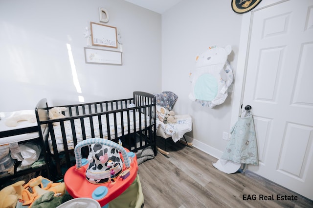 bedroom featuring baseboards and wood finished floors