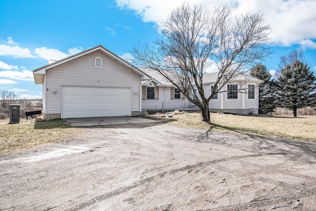 single story home with dirt driveway and an attached garage