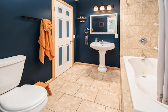 full bathroom with toilet, baseboards, and tile patterned floors