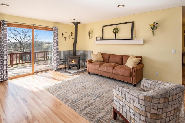 living room with wood finished floors and a wood stove