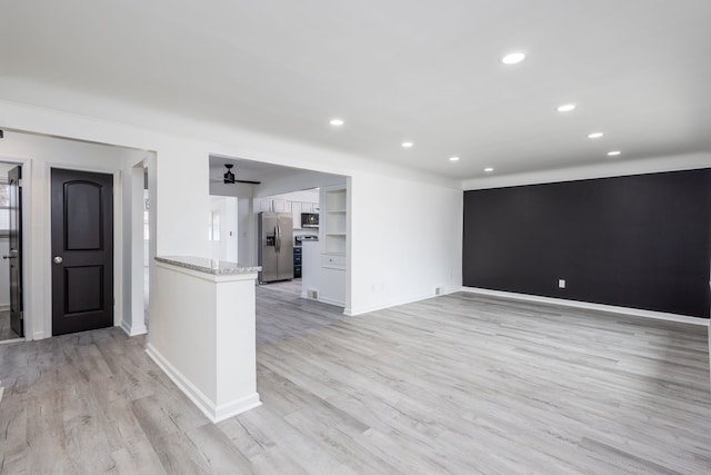 empty room featuring recessed lighting, a ceiling fan, light wood-type flooring, and baseboards