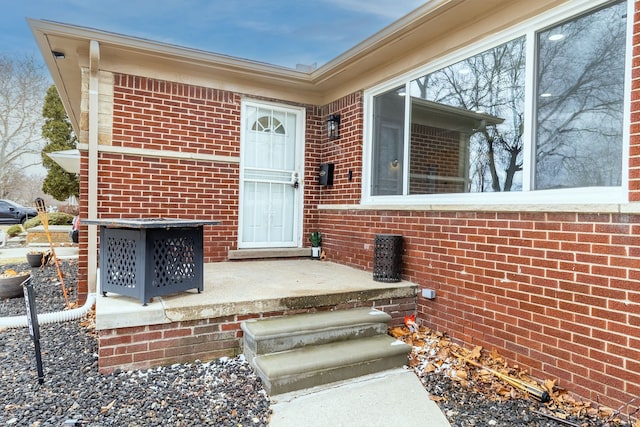 entrance to property with brick siding