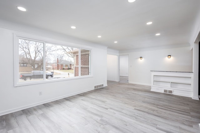 interior space featuring recessed lighting, visible vents, baseboards, and wood finished floors