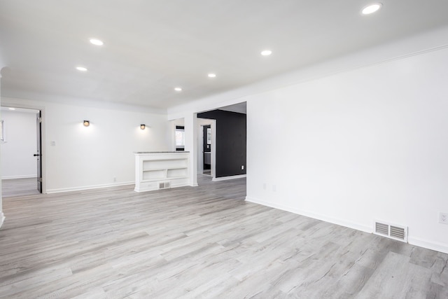 unfurnished room featuring recessed lighting, light wood-style floors, visible vents, and baseboards