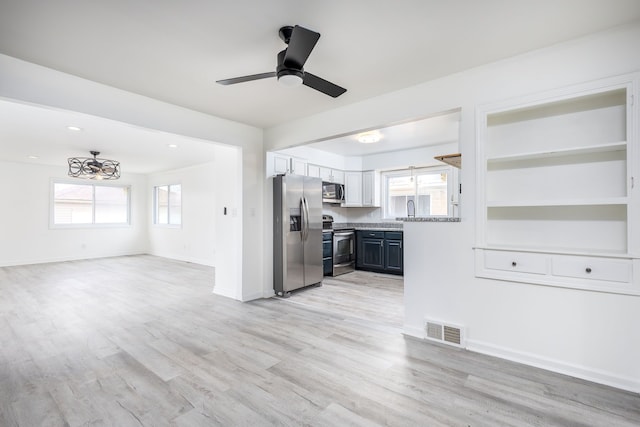 kitchen featuring open floor plan, light wood-style flooring, visible vents, and appliances with stainless steel finishes