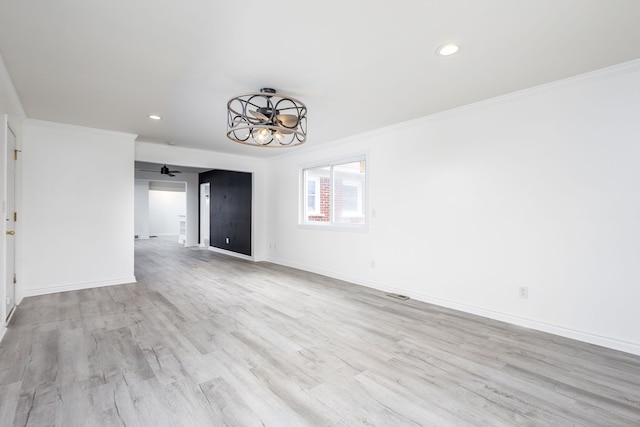 interior space featuring recessed lighting, baseboards, wood finished floors, and crown molding