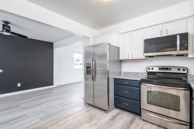 kitchen featuring light stone countertops, ceiling fan, stainless steel appliances, white cabinetry, and light wood-type flooring