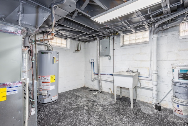 below grade area with gas water heater, electric panel, and a sink