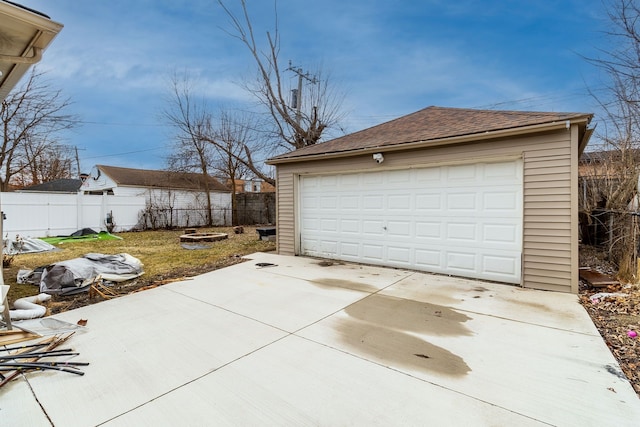 detached garage featuring fence