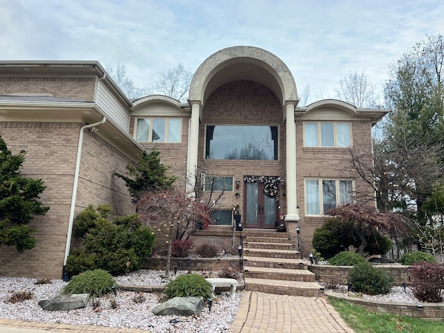 view of front of house featuring french doors and brick siding