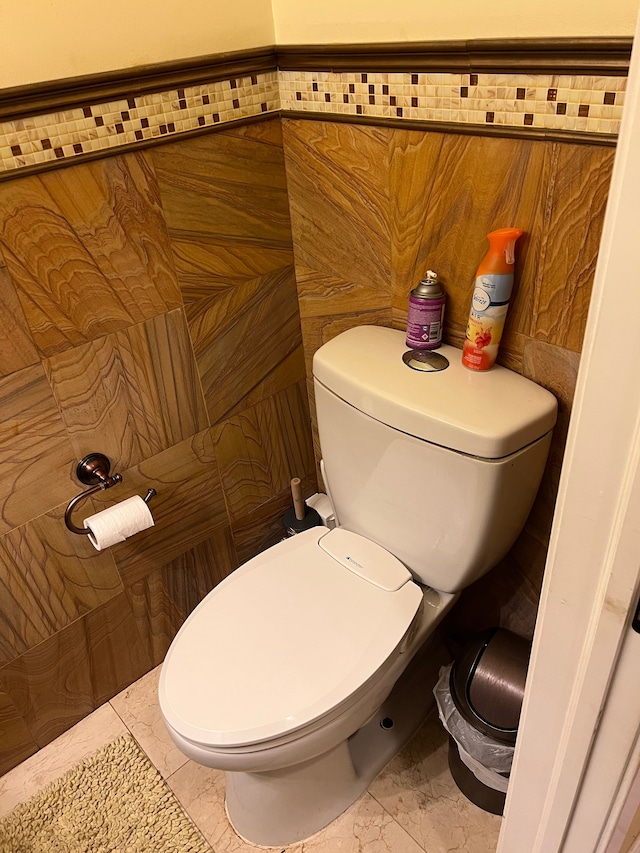 bathroom featuring marble finish floor and toilet