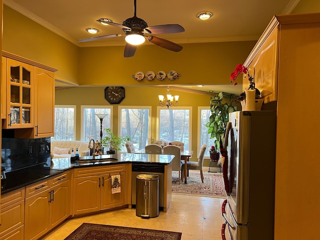 kitchen with ornamental molding, glass insert cabinets, freestanding refrigerator, a peninsula, and a sink