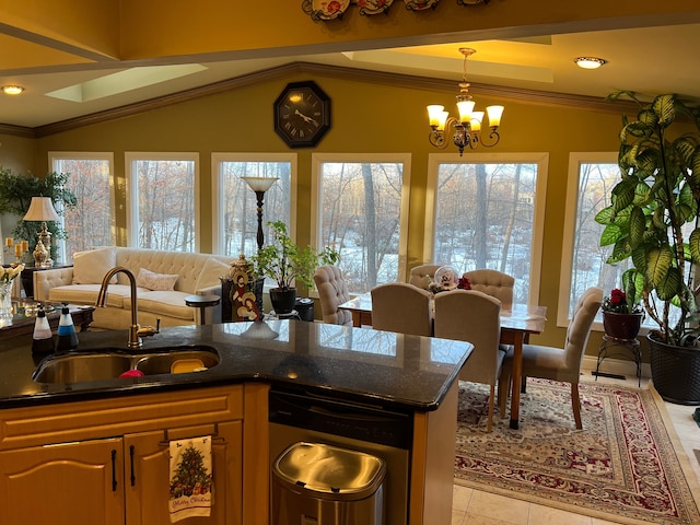 kitchen with open floor plan, ornamental molding, a sink, and a notable chandelier