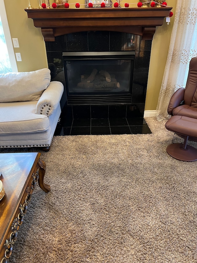 details with baseboards and a tiled fireplace