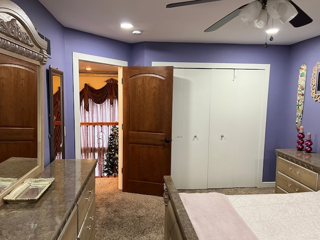 carpeted bedroom featuring a ceiling fan and a closet