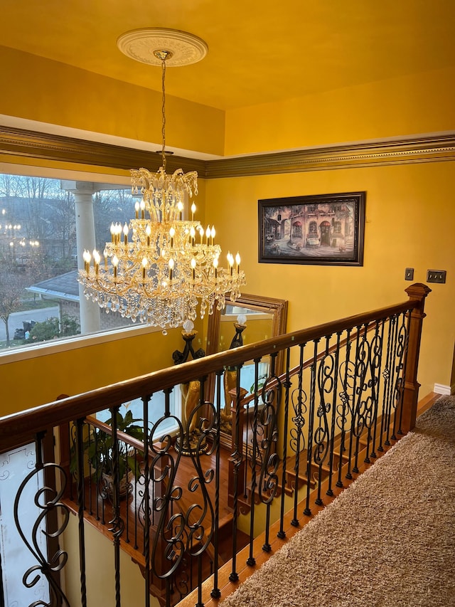 interior space featuring a chandelier, carpet floors, and an upstairs landing