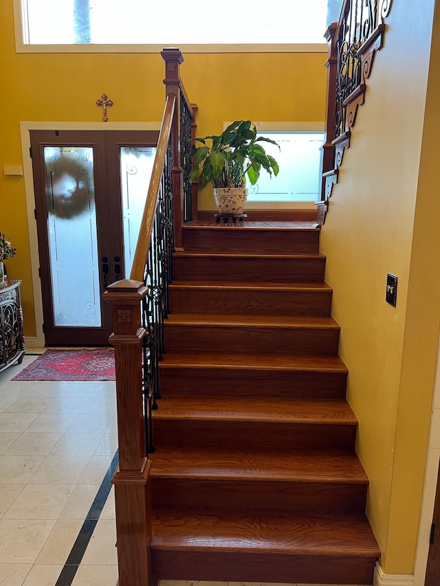 staircase featuring french doors