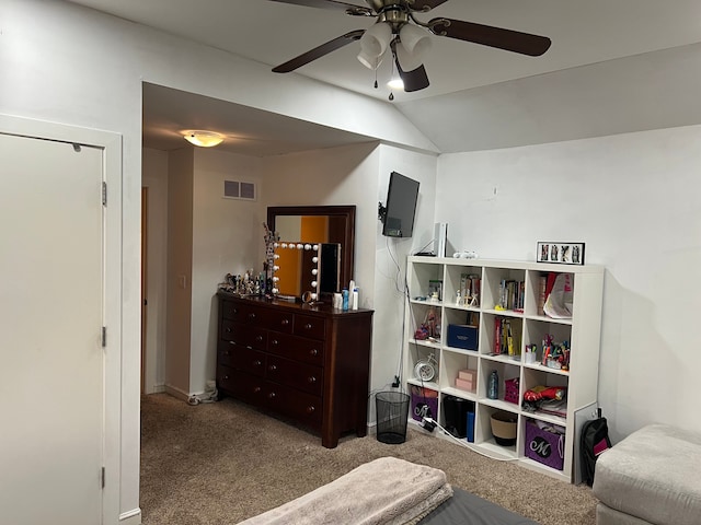 carpeted bedroom featuring ceiling fan, vaulted ceiling, and visible vents