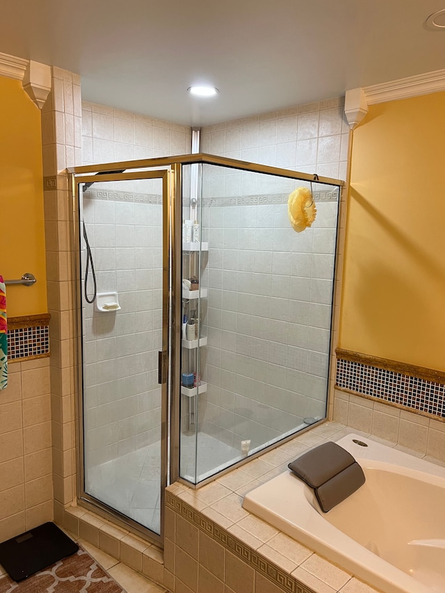 full bath with a garden tub, ornamental molding, and a shower stall