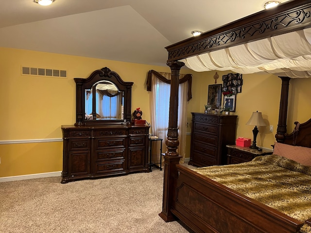 bedroom featuring light carpet, baseboards, visible vents, and lofted ceiling