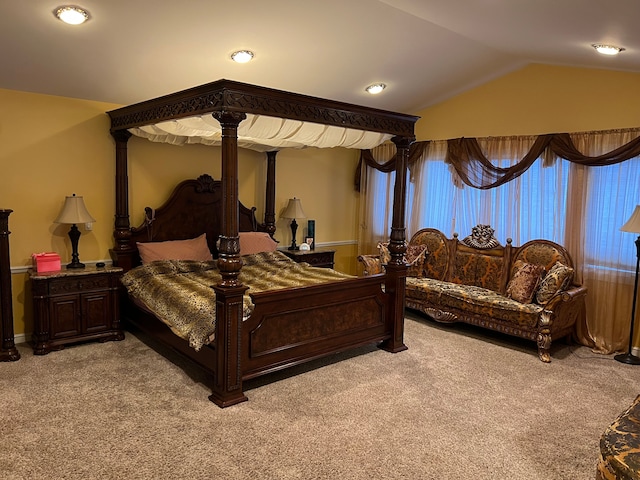 bedroom with vaulted ceiling and light colored carpet