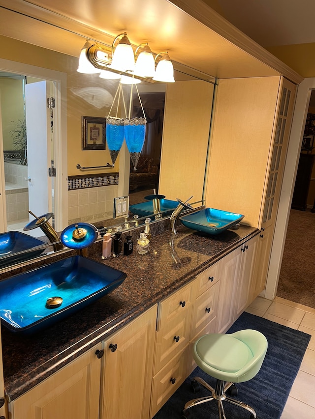 full bathroom featuring double vanity, a sink, and tile patterned floors