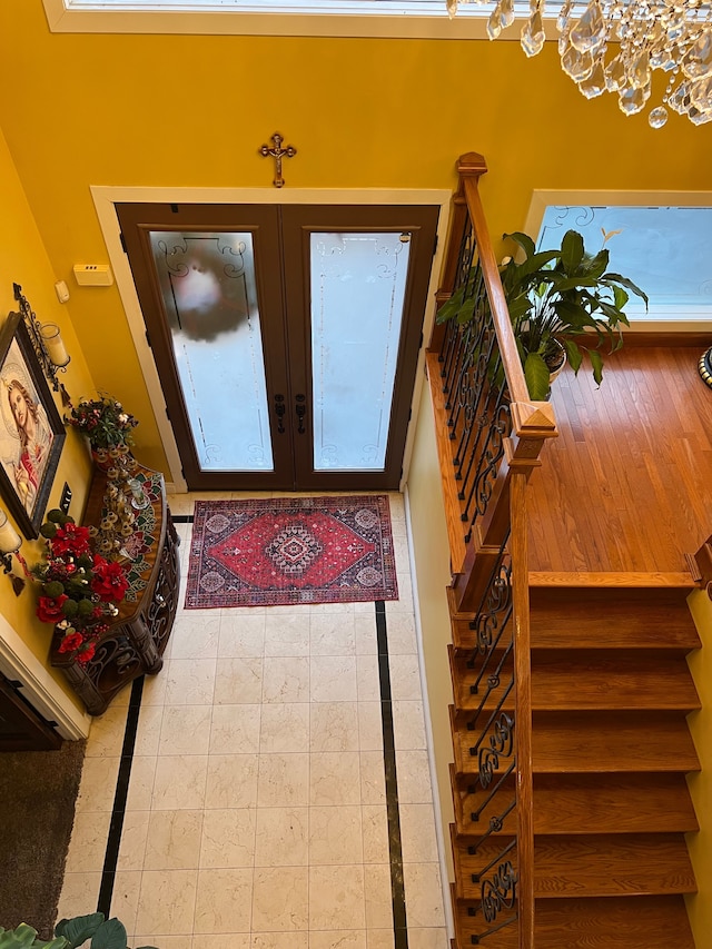 foyer featuring stairs and french doors