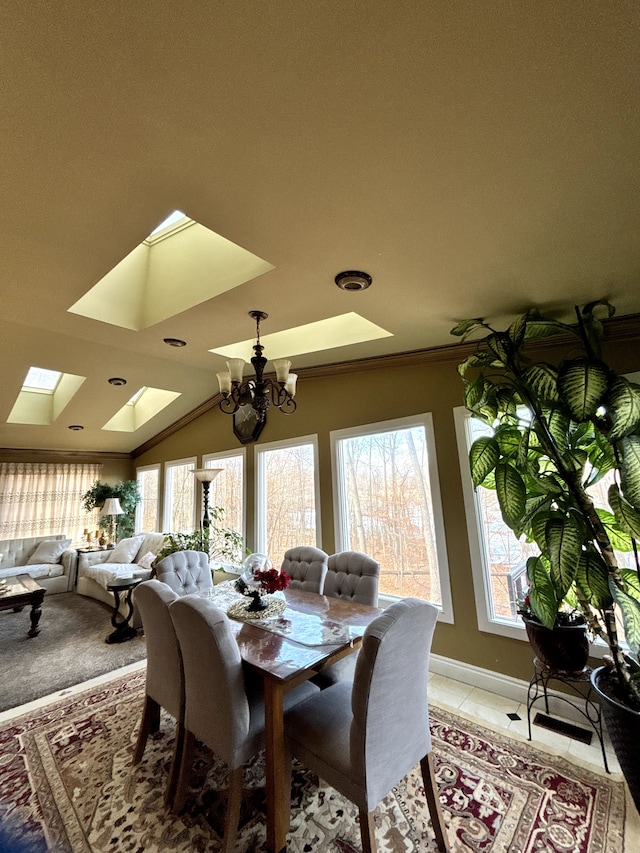 dining space featuring lofted ceiling with skylight, a wealth of natural light, light tile patterned flooring, and an inviting chandelier