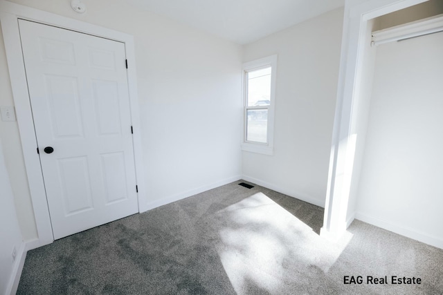 unfurnished bedroom with carpet floors and baseboards