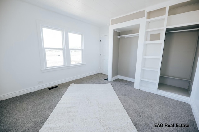 unfurnished bedroom with carpet, visible vents, and baseboards