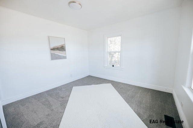 carpeted empty room with baseboards