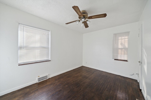 spare room featuring visible vents, baseboards, a ceiling fan, and hardwood / wood-style flooring