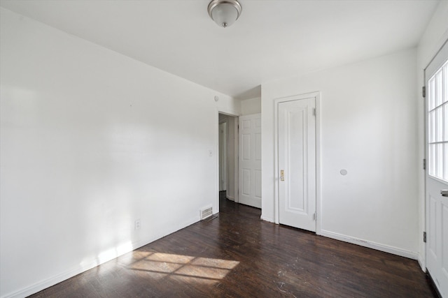 interior space featuring visible vents, baseboards, and wood finished floors