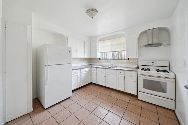 kitchen with decorative backsplash, white appliances, wall chimney range hood, and a sink