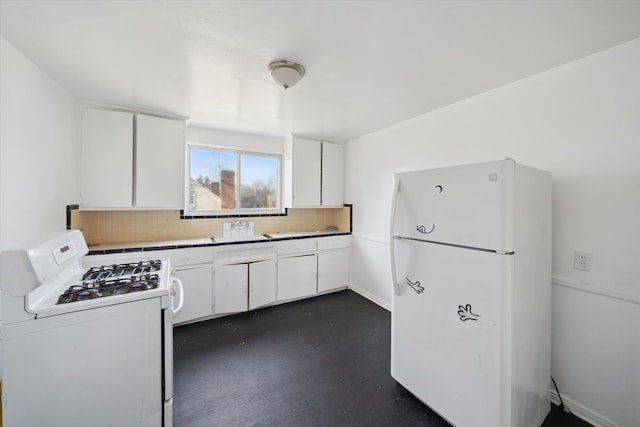 kitchen with decorative backsplash, white cabinets, and white appliances