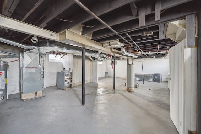 basement featuring heating unit, electric water heater, and water heater