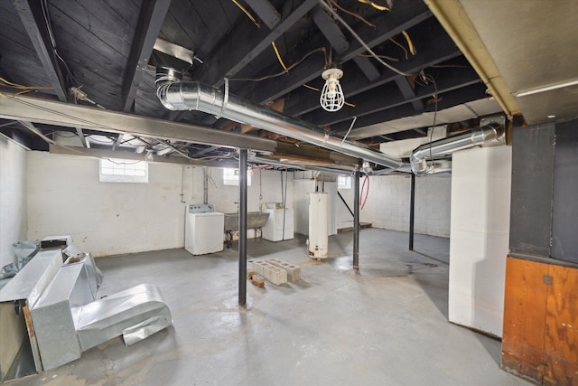 basement featuring gas water heater, washer / clothes dryer, and a sink