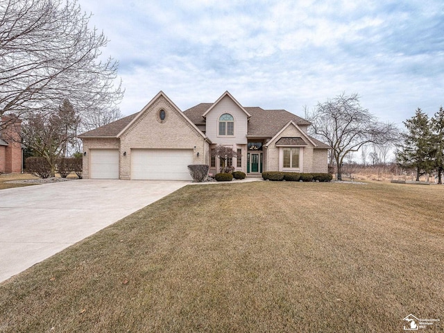 traditional-style house featuring driveway, a shingled roof, an attached garage, a front yard, and brick siding