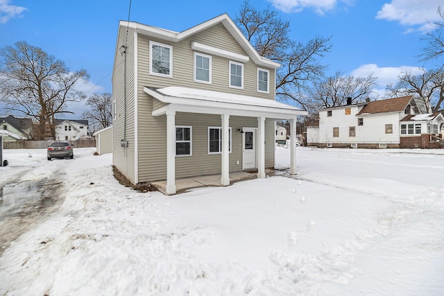 view of front of home featuring covered porch and fence