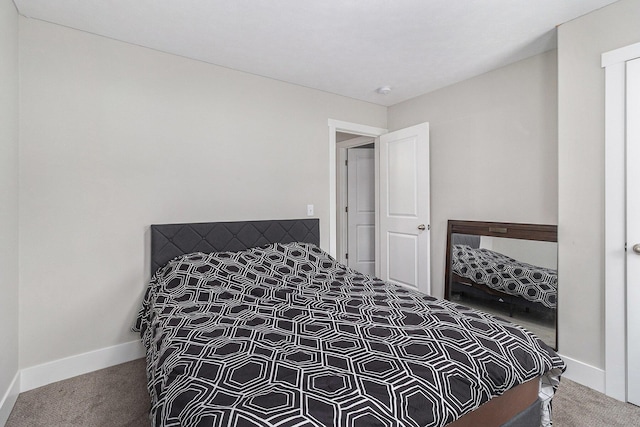 bedroom with carpet floors and baseboards