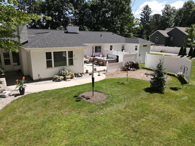 back of house featuring a shingled roof, fence, a chimney, and a lawn