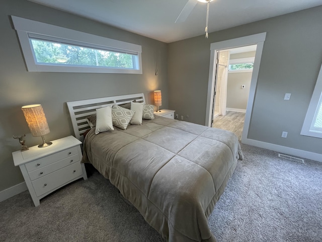 carpeted bedroom featuring visible vents and baseboards