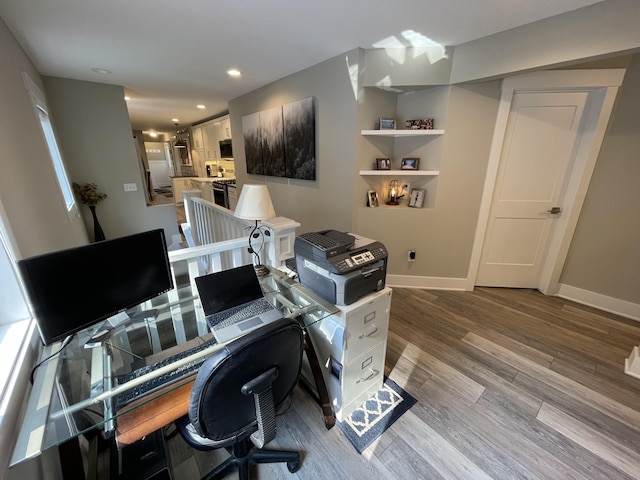 home office featuring light wood-style floors, recessed lighting, and baseboards