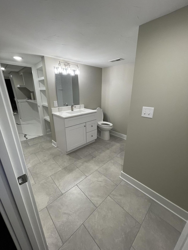 bathroom with baseboards, visible vents, built in features, toilet, and vanity