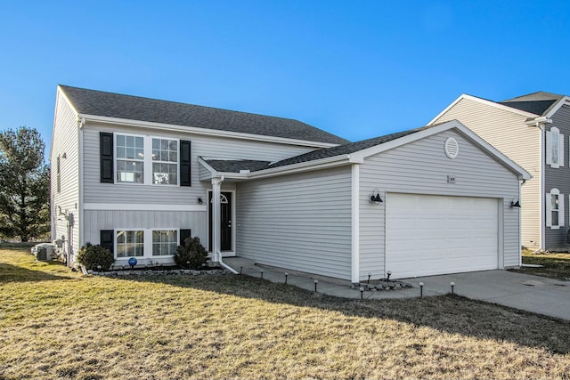 split level home featuring a front lawn, roof with shingles, driveway, and an attached garage