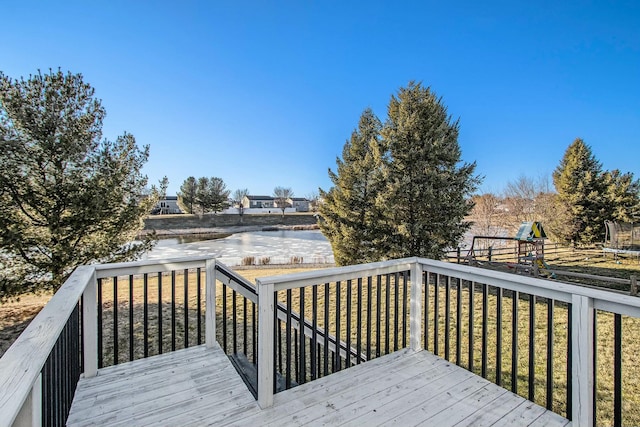 deck featuring a playground and a lawn