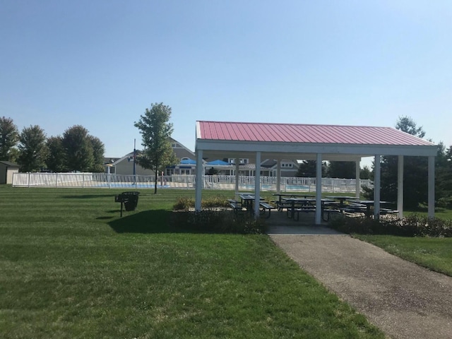 surrounding community featuring a lawn and fence