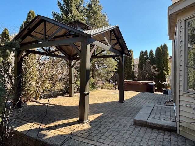 view of patio featuring a gazebo and a hot tub