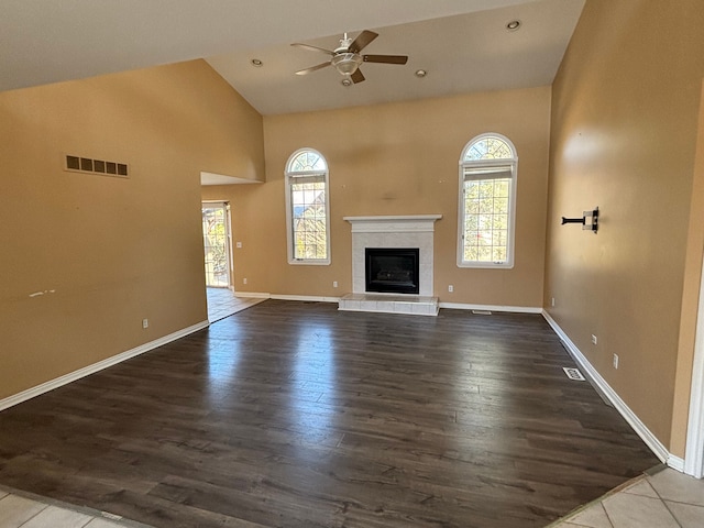 unfurnished living room with dark wood-type flooring, a fireplace, visible vents, and baseboards